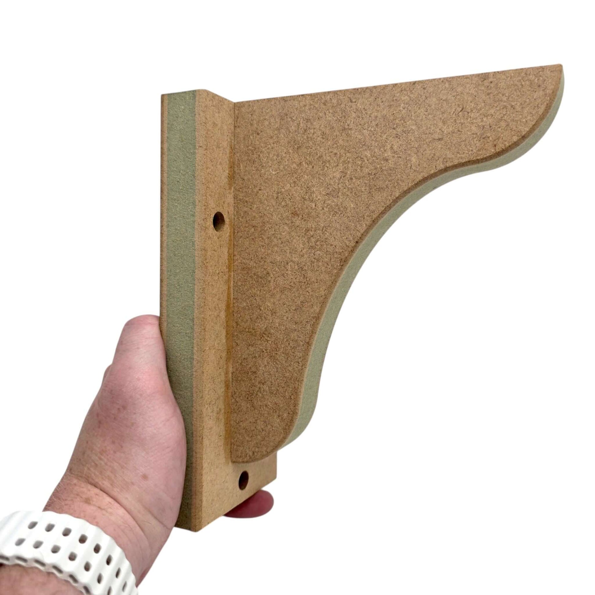 Hand holding a Shaker Gallows Bracket, showcasing its precision-crafted design and moisture-resistant material.