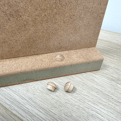 Shaker Gallows Bracket components including a backplate and wooden mushrooms on a wooden surface.