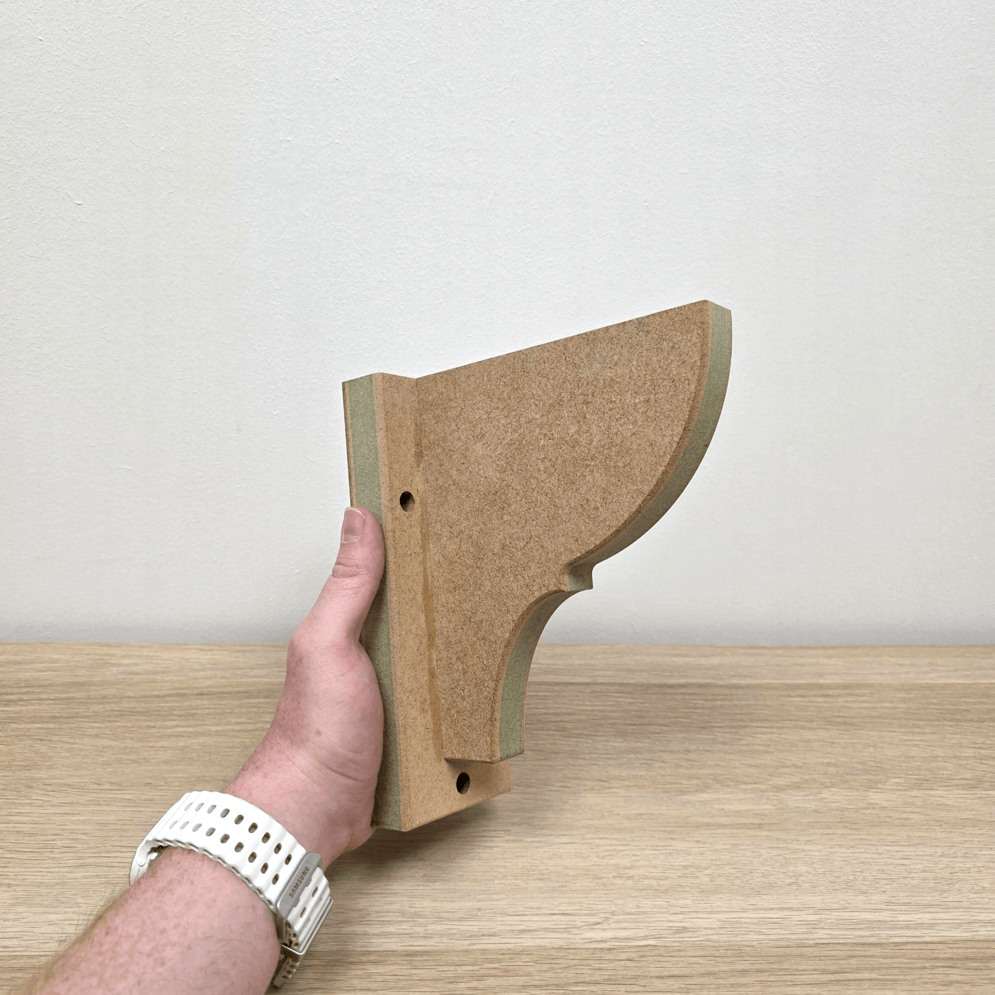 Shaker Gallows Bracket displayed being held, showcasing precision-crafted design and durable construction.