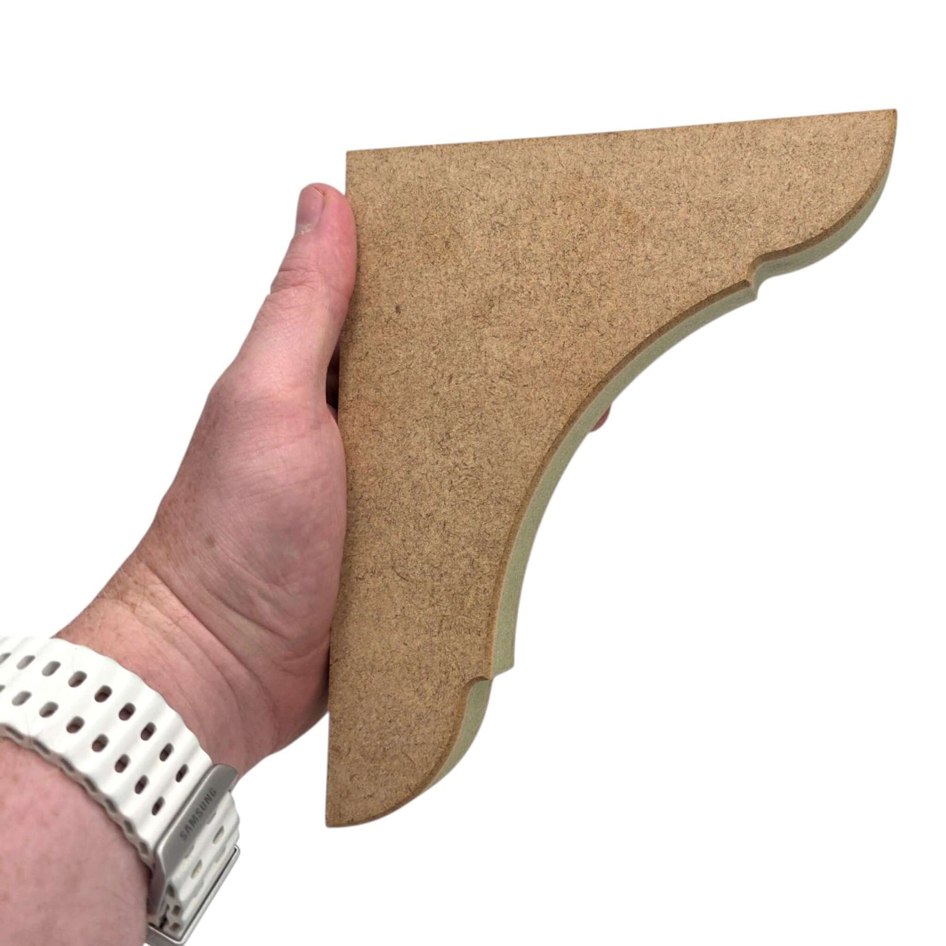 Close-up of hand holding a Traditional Shaker Shelf Bracket - Style 1 made from premium MDF.