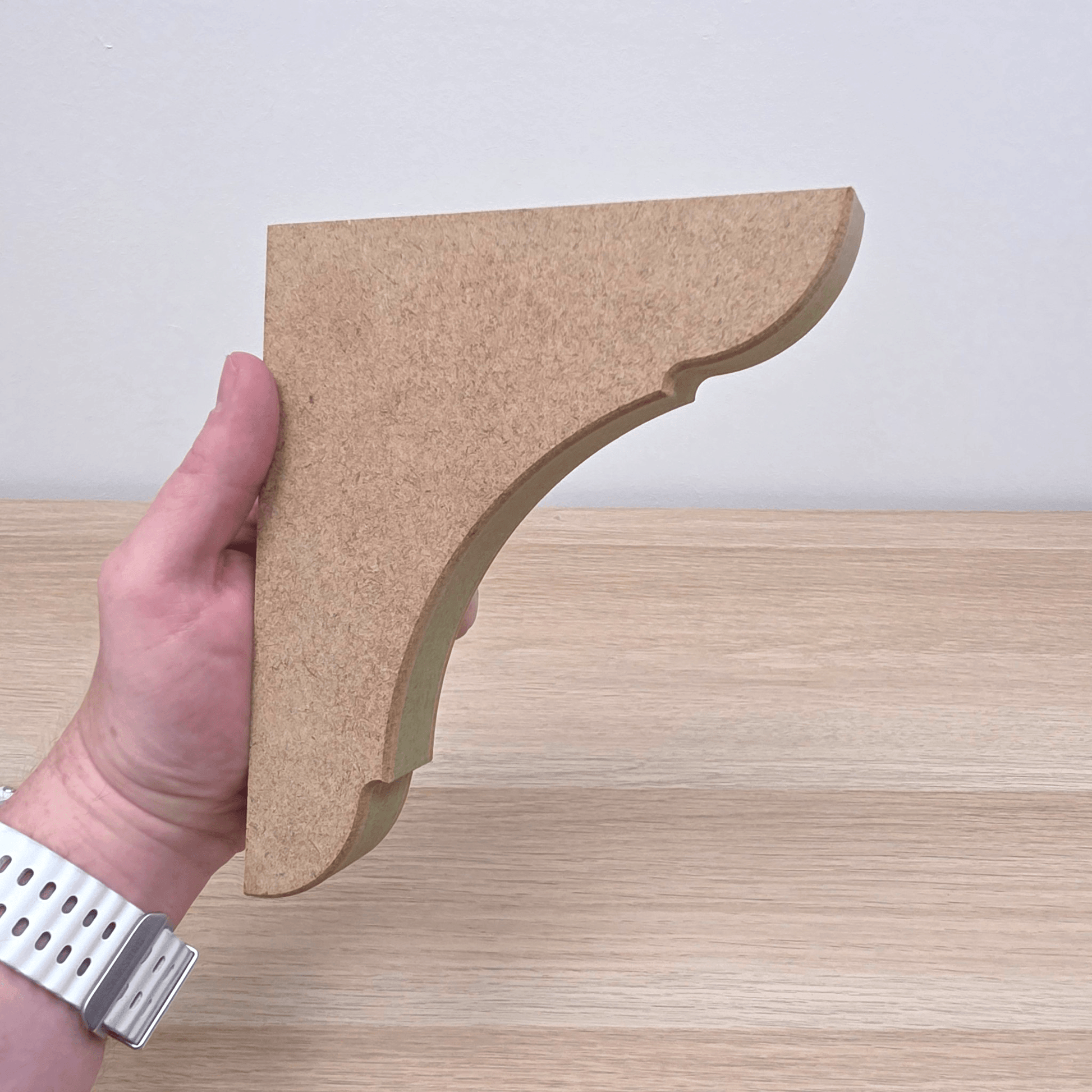 Traditional Shaker Shelf Bracket - Style 1 held in hand, showcasing clean profile and craftsmanship.