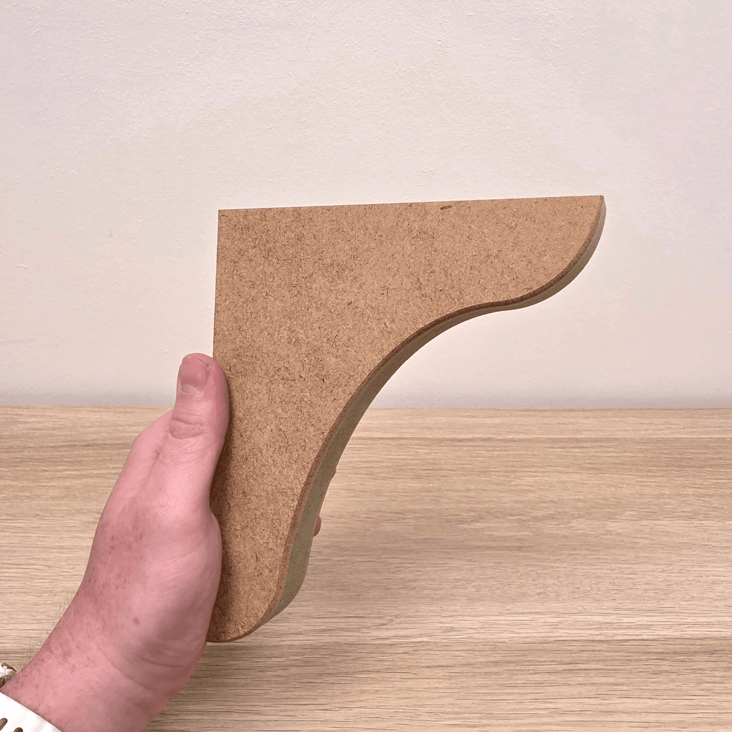 Traditional Shaker Shelf Bracket held by hand, showcasing its precision-crafted MDF design for shelf support.