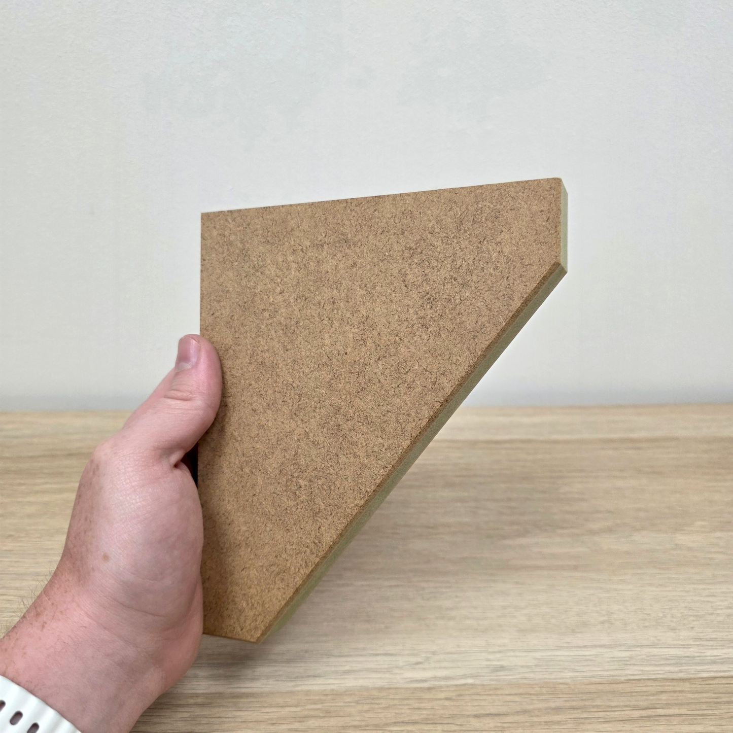 Traditional Shaker Shelf Bracket held from the side, showcasing its precision craftsmanship and premium MDF material.