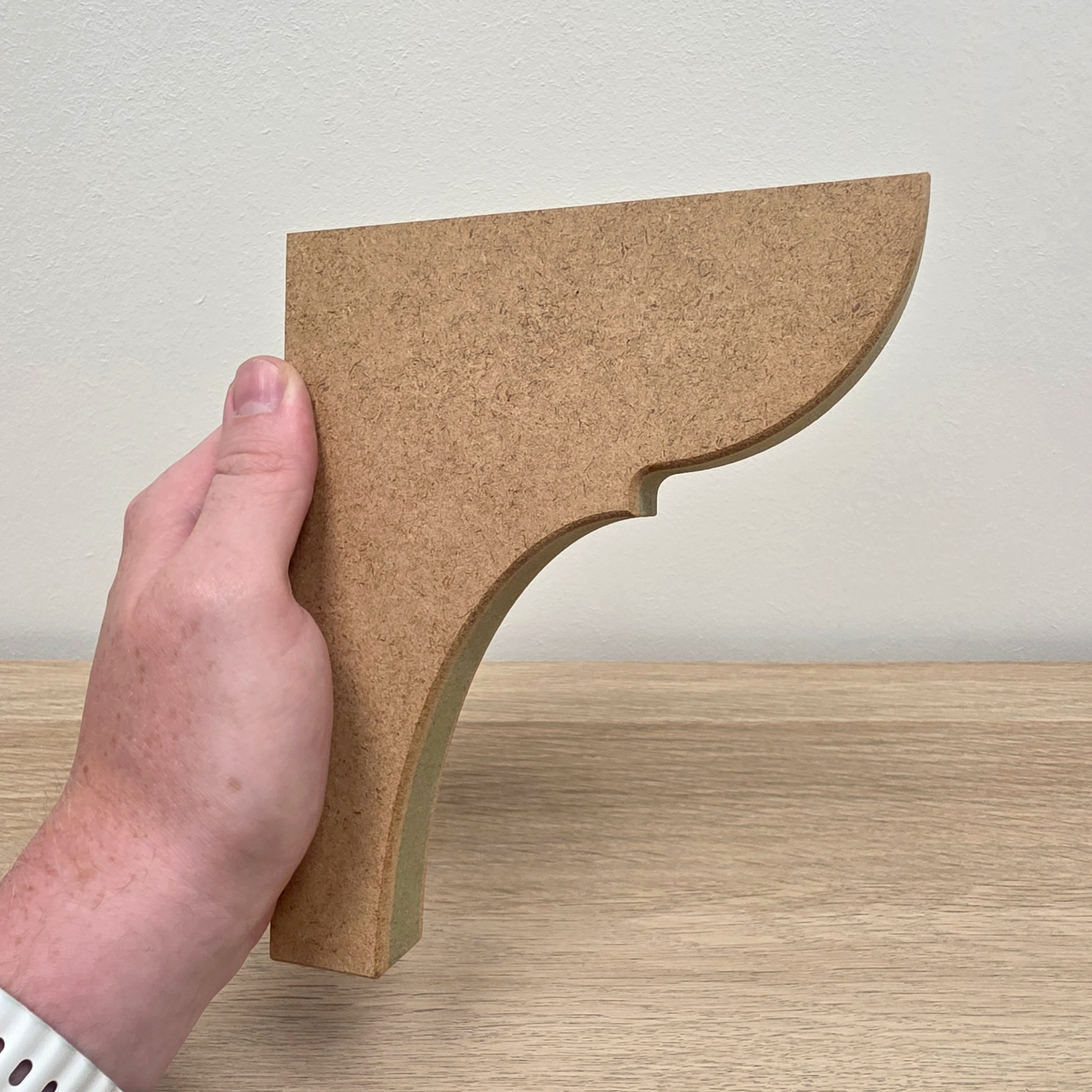 Traditional Shaker Shelf Bracket held in hand, showcasing smooth contours and premium MDF design.