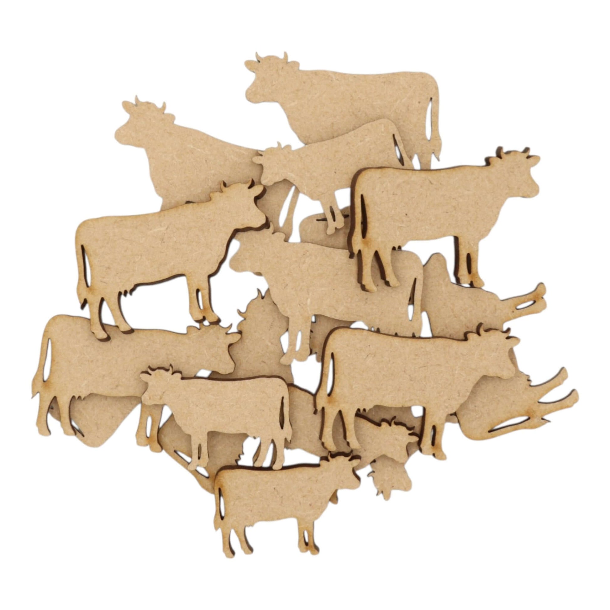 A collection of laser-cut Cow MDF Craft Shapes in various positions, perfect for rustic décor and craft projects.